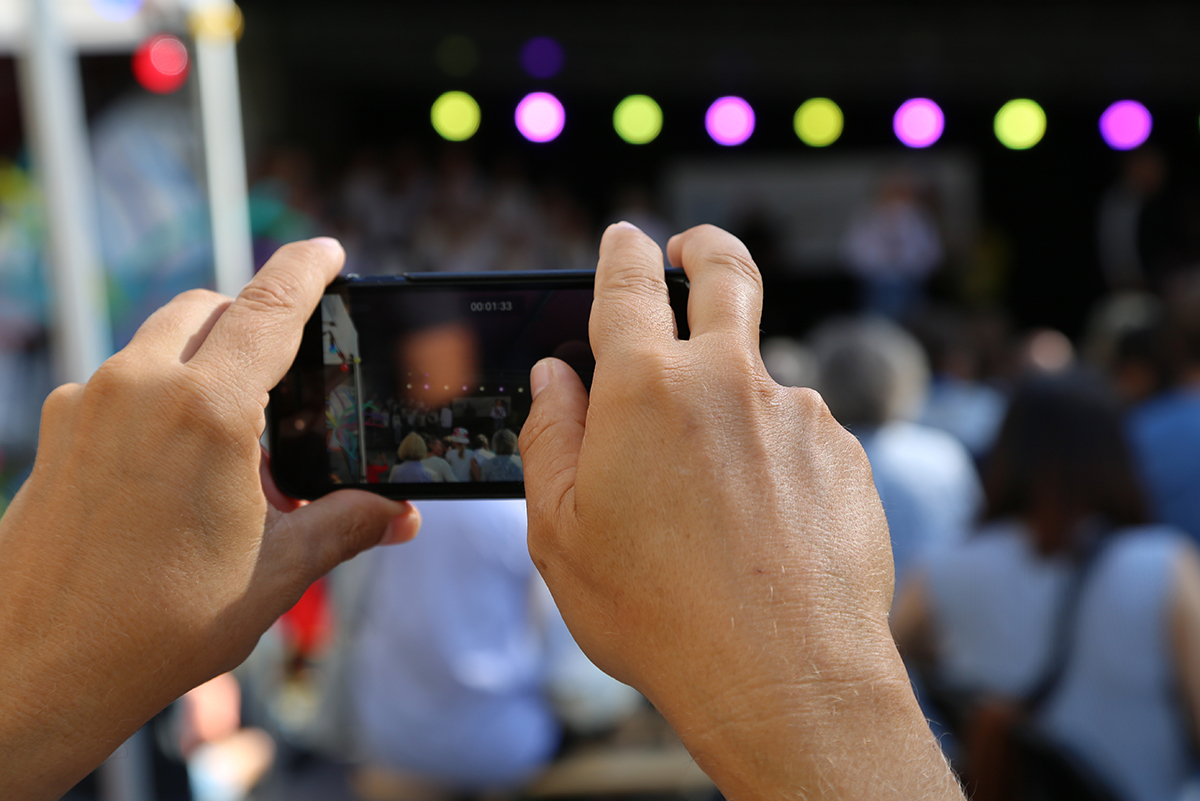 Person tar bilde med sin mobil på konsert
